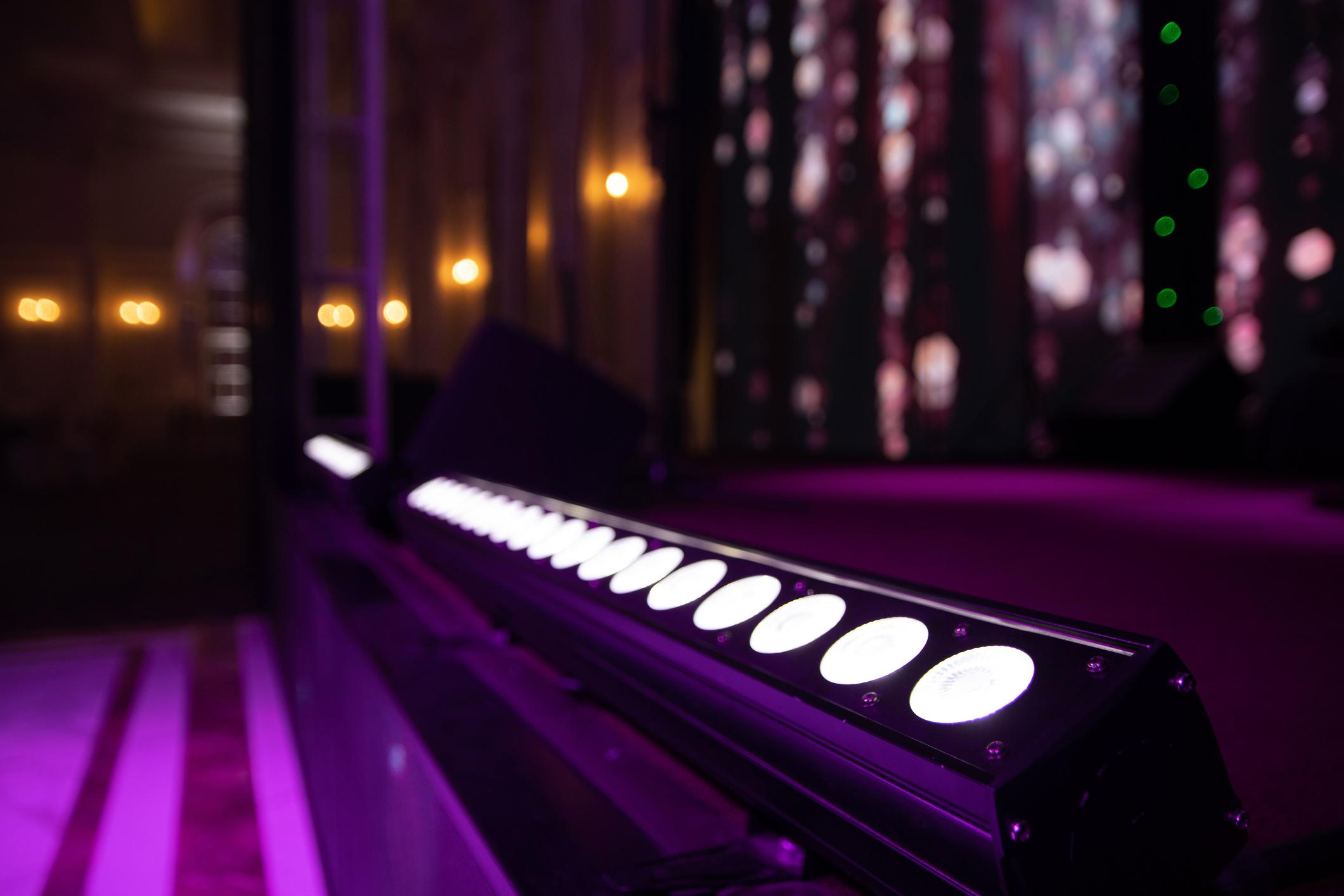 Stage lighting rig with beams and atmosphere for live event production.