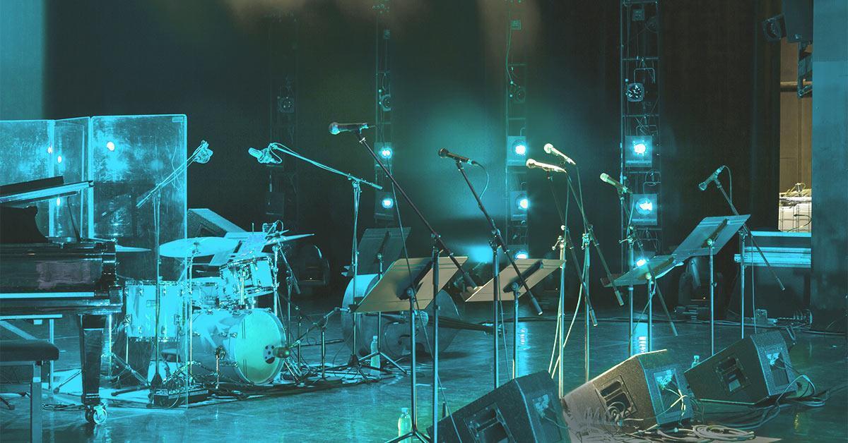 Live sound system setup with stage microphones, PA coverage, and front-of-house support for performance.